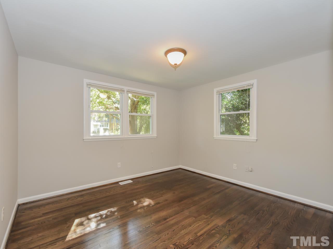 3441 Cheyenne Road Raleigh, NC 27609 - Photo 11 of 22 an empty room with wooden floor and windows