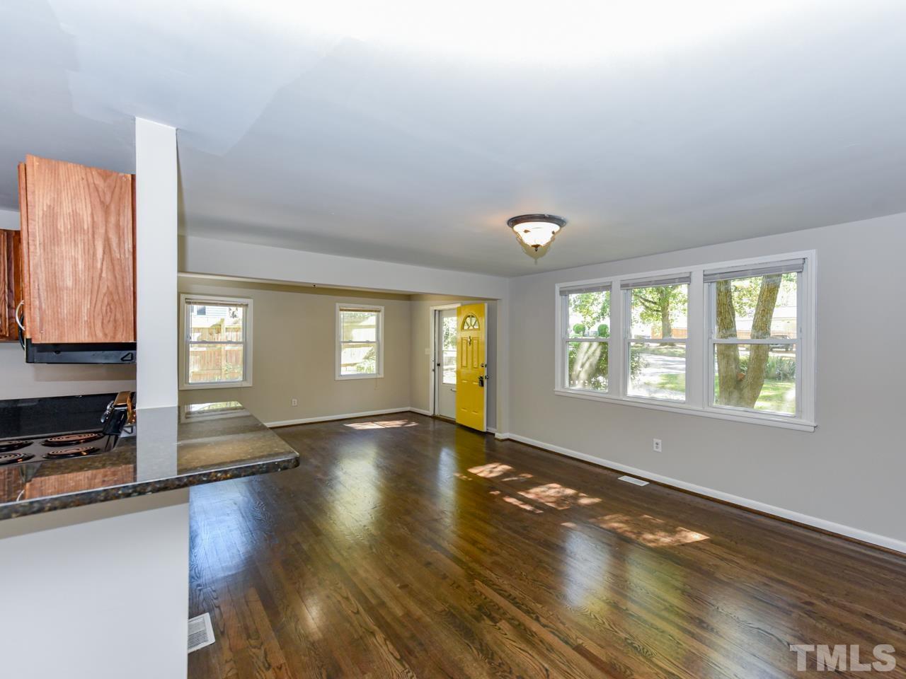 3441 Cheyenne Road Raleigh, NC 27609 - Photo 5 of 22 a view of an empty room with wooden floor and a window