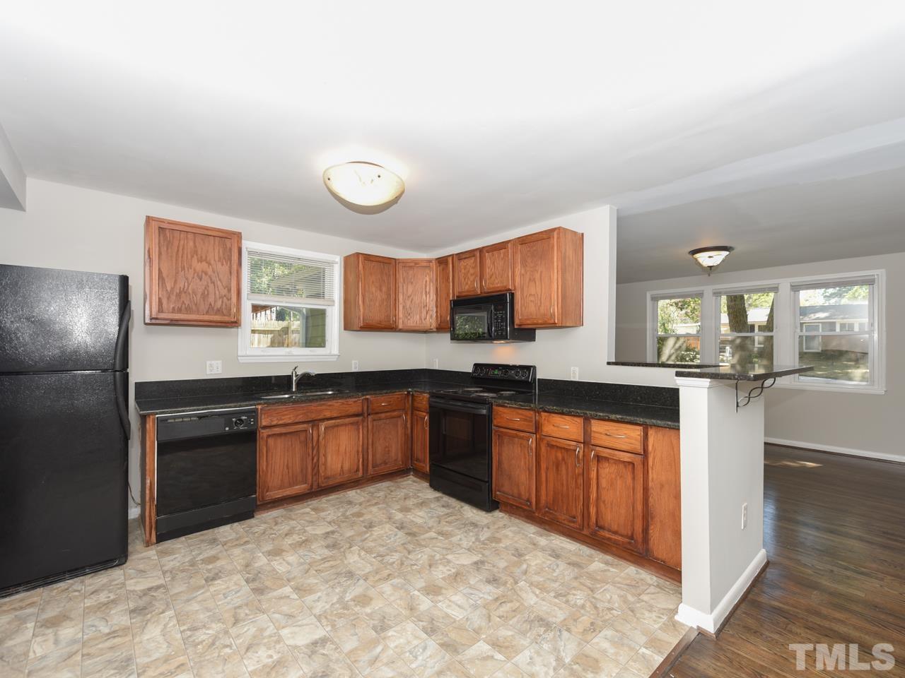3441 Cheyenne Road Raleigh, NC 27609 - Photo 8 of 22 a large kitchen with stainless steel appliances granite countertop a stove sink and cabinets