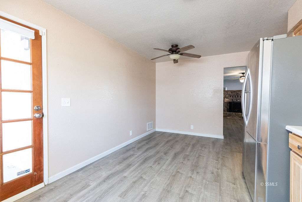 220 South American Street Ridgecrest, CA 93555 - Photo 12 of 25 wooden floor in an empty room with a window