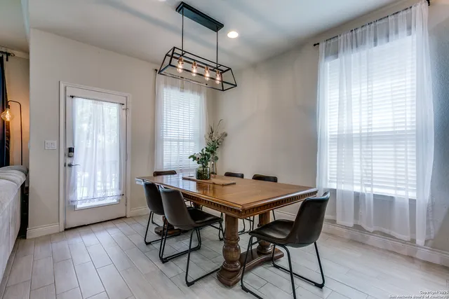 a view of a dining room with furniture window and wooden floor