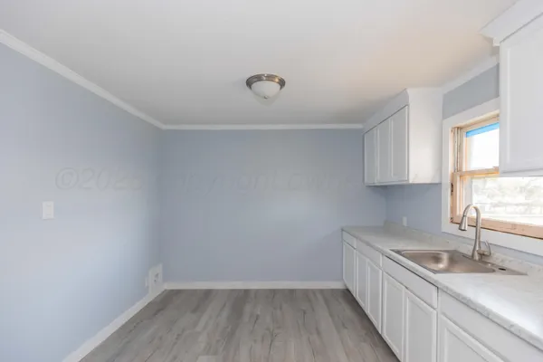 a kitchen with a sink cabinets and window