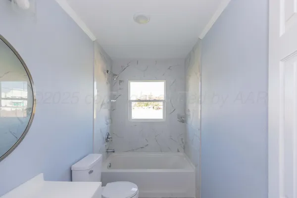a bath room with a toilet and a bath tub