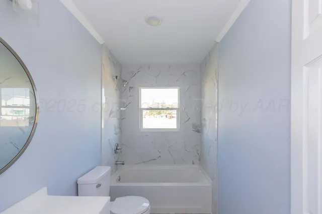 a bath room with a toilet and a bath tub