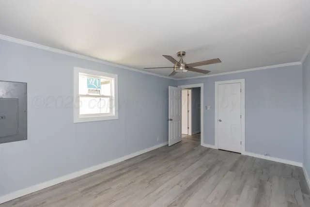 a view of a livingroom with a ceiling fan & wooden floor