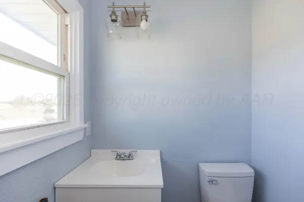 a bathroom with a toilet and a window