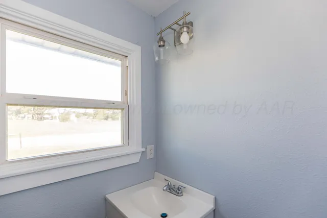 a bathroom with a sink window and shower