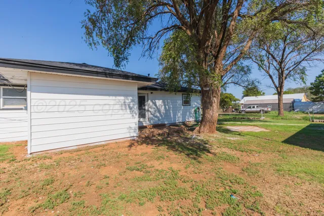 a view of a house with a yard and garage