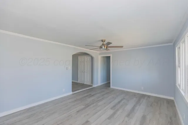 a view of an empty room with wooden floor