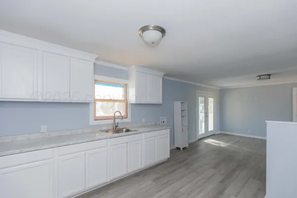 a kitchen with sink and cabinets