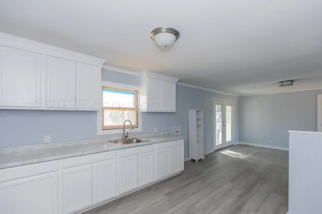 a kitchen with sink and cabinets