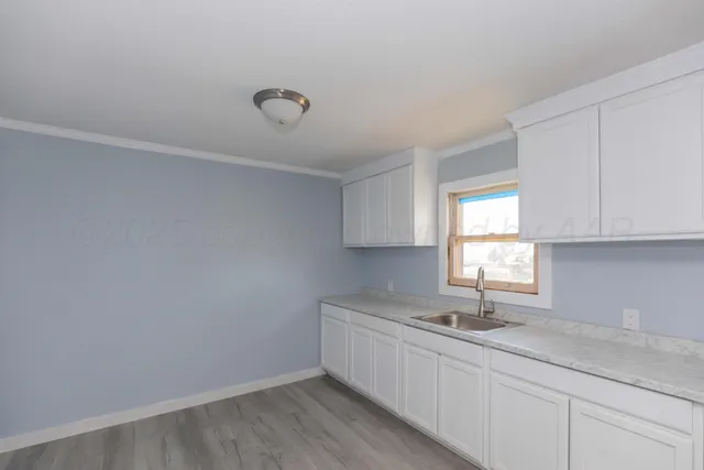 a kitchen with a sink cabinets and window