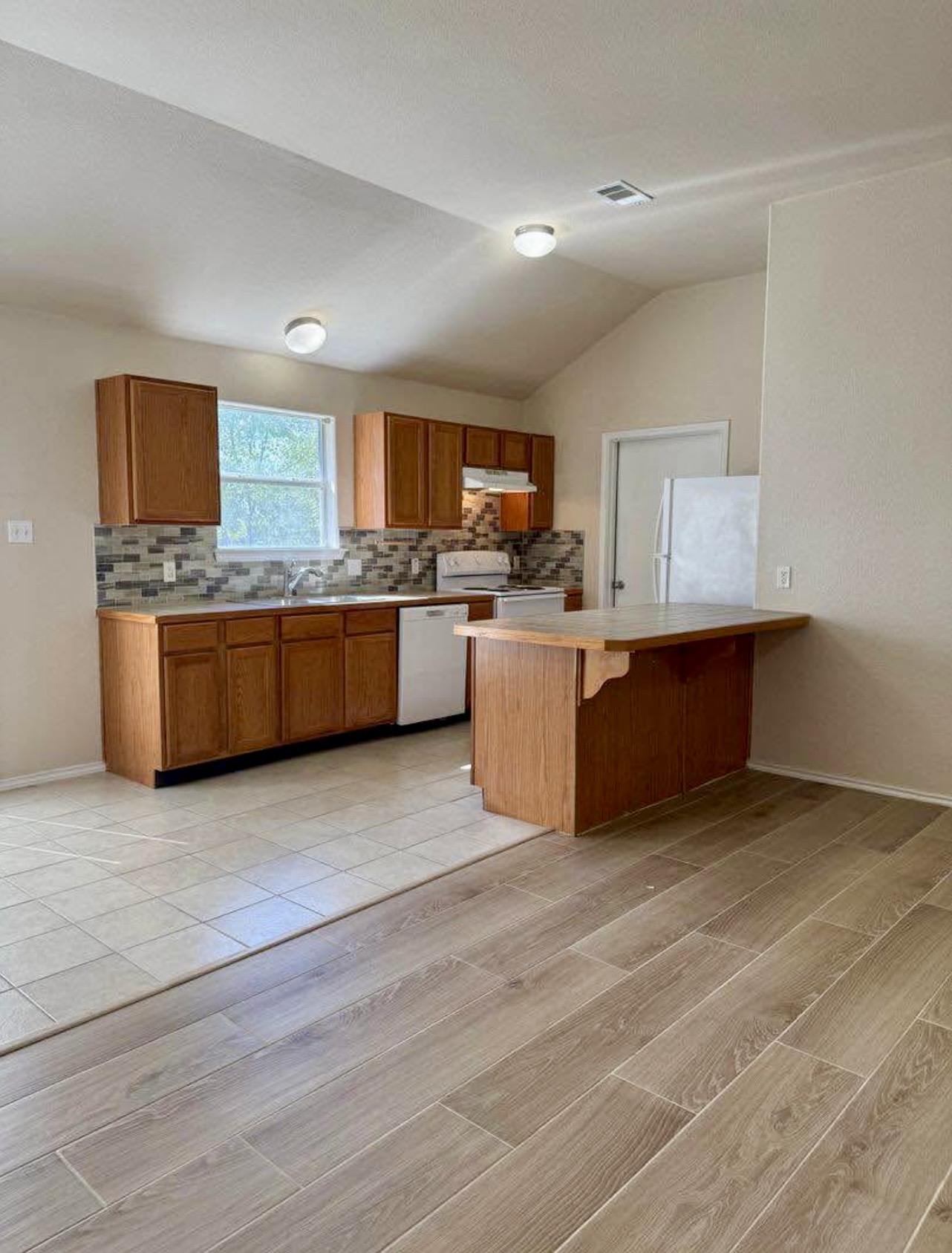 400 Blue Shale Drive Jarrell, TX 76537 - Photo 12 of 22 a large kitchen with granite countertop a sink and cabinets