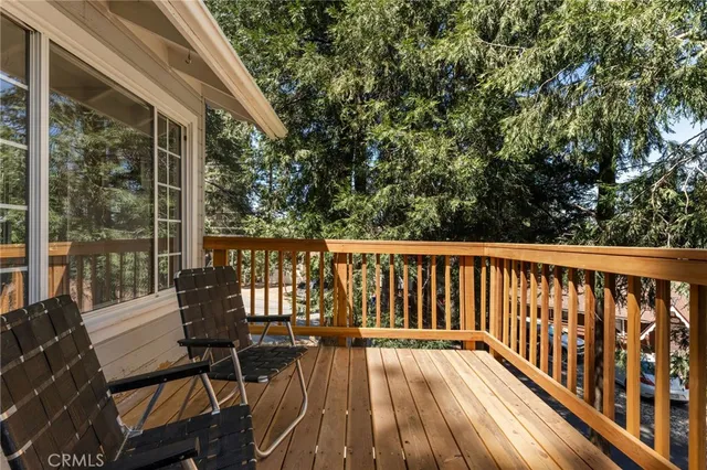 a view of balcony with wooden floor and outdoor seating