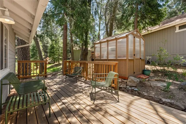 a view of a chairs and table on the wooden deck