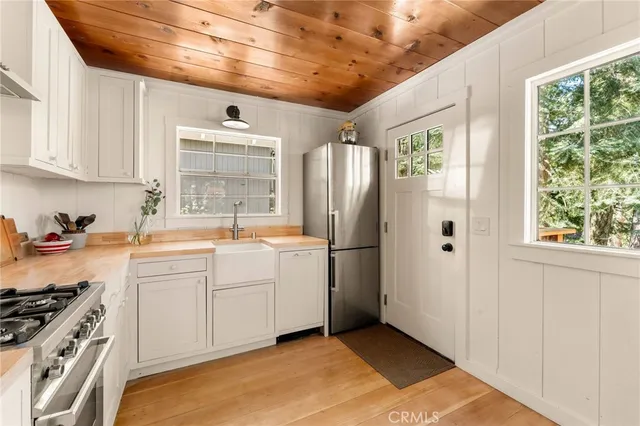 a kitchen with a sink stainless steel appliances and cabinets