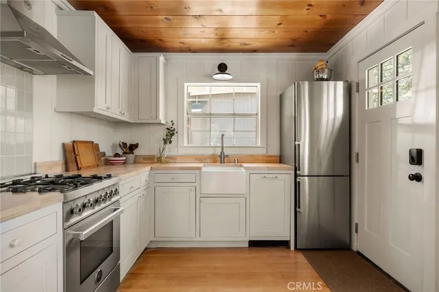 a kitchen with a refrigerator sink and cabinets