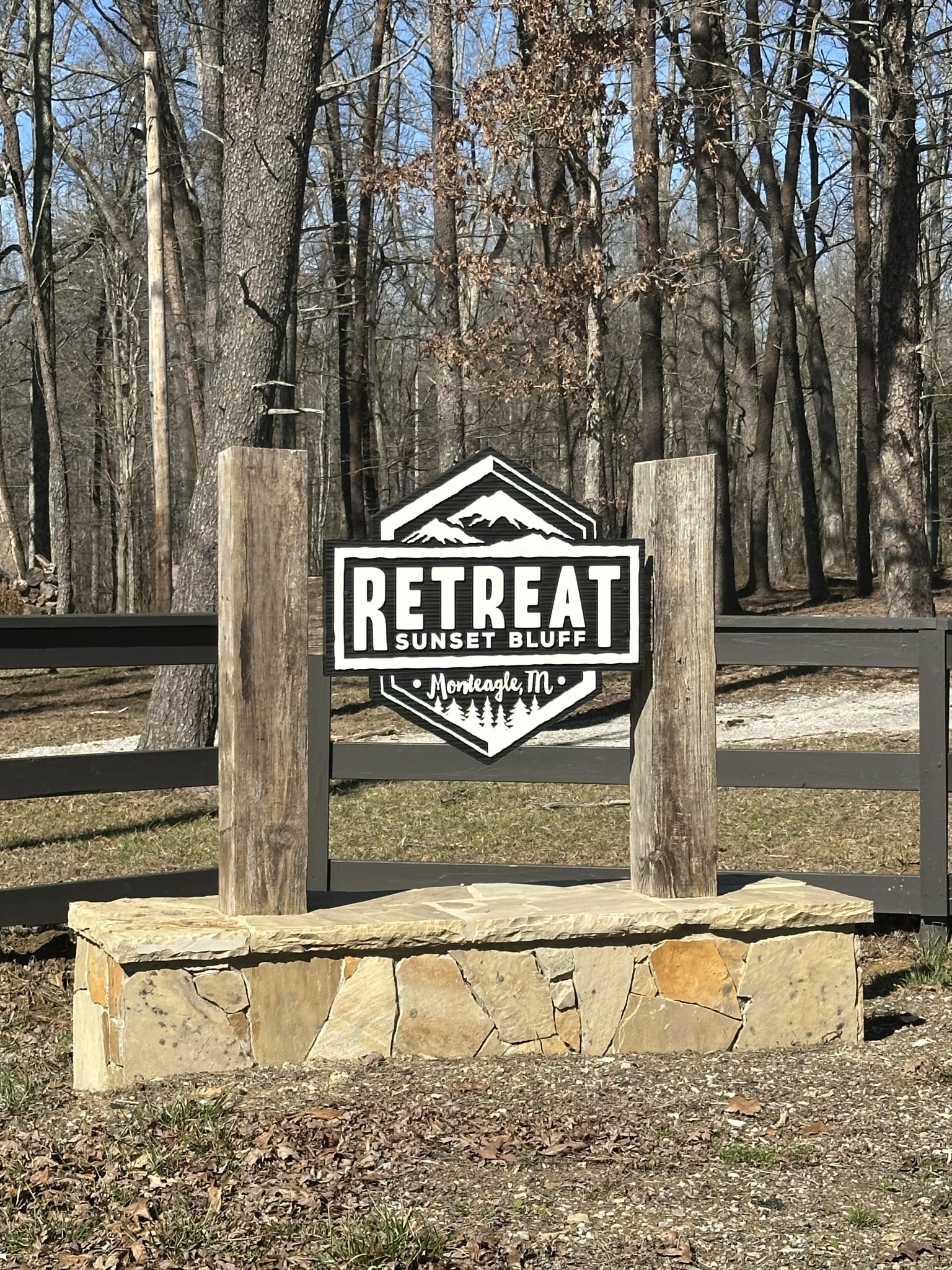 a view of a wooden fence next to a road