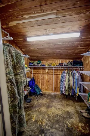 a view of walk in closet with clothes