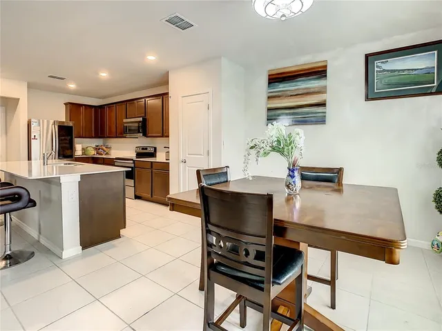 a living room with furniture a flat screen tv and kitchen view