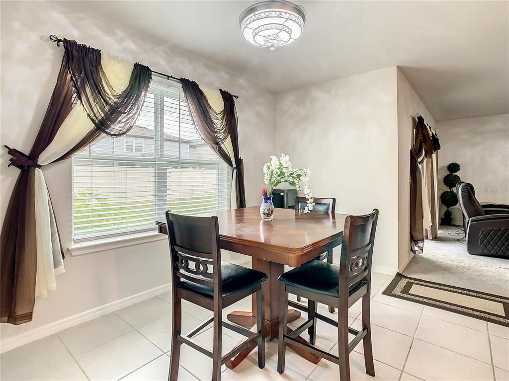30344 Marquette Avenue Wesley Chapel, FL 33545 - Photo 14 of 71 a dining room with furniture and window