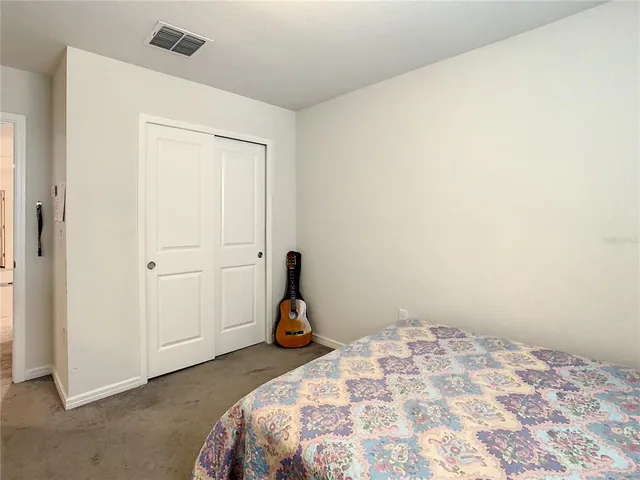 a bedroom with a bed and cabinets