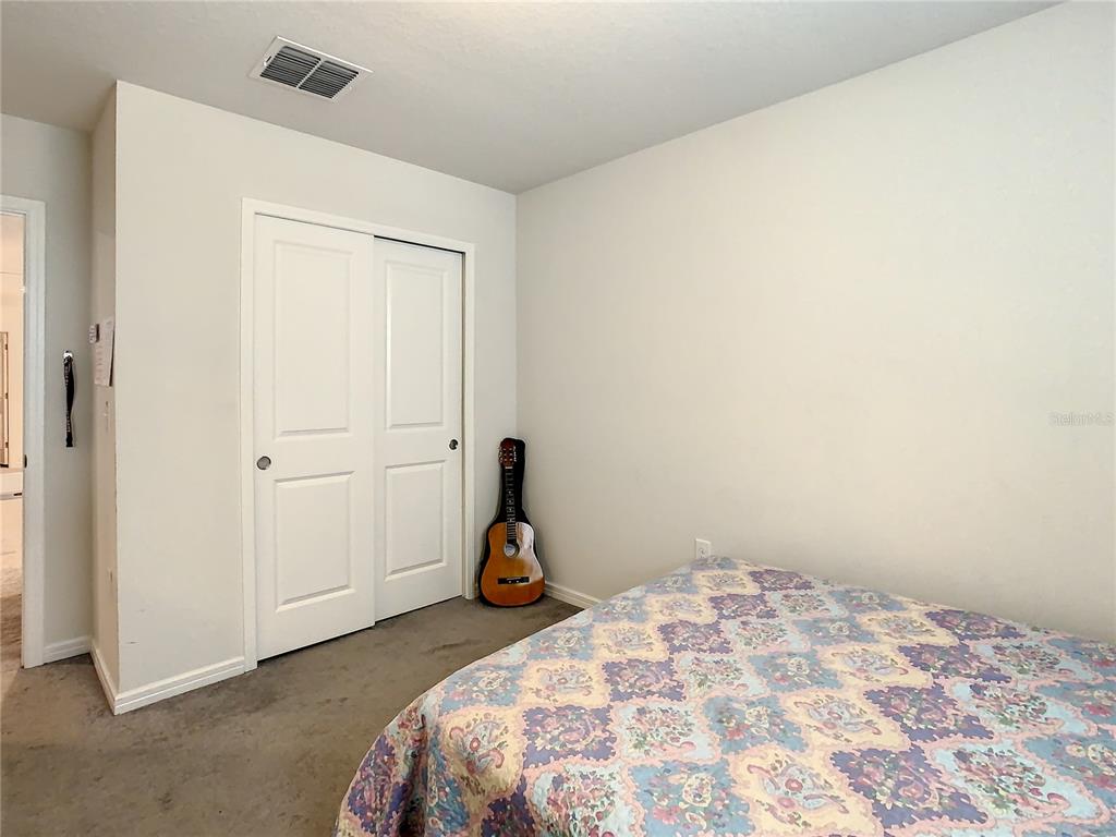 30344 Marquette Avenue Wesley Chapel, FL 33545 - Photo 25 of 71 a bedroom with a bed and a window