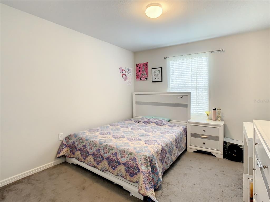 30344 Marquette Avenue Wesley Chapel, FL 33545 - Photo 27 of 71 a bedroom with a bed and a window