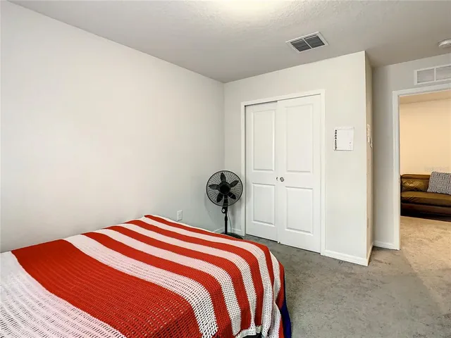 a bathroom with a sink a toilet a mirror and shower curtain