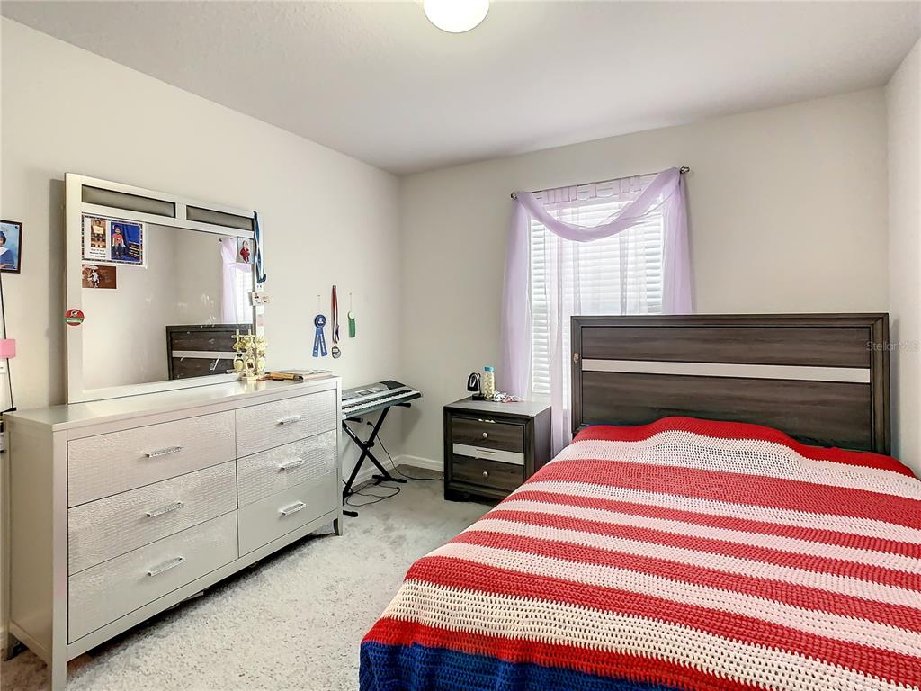 30344 Marquette Avenue Wesley Chapel, FL 33545 - Photo 29 of 71 a bedroom with a bed and furniture