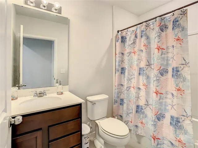 a bed sitting in a bedroom next to a window with dresser