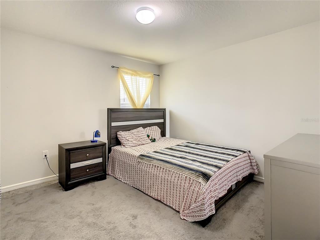 30344 Marquette Avenue Wesley Chapel, FL 33545 - Photo 34 of 71 a bedroom with a bed and window