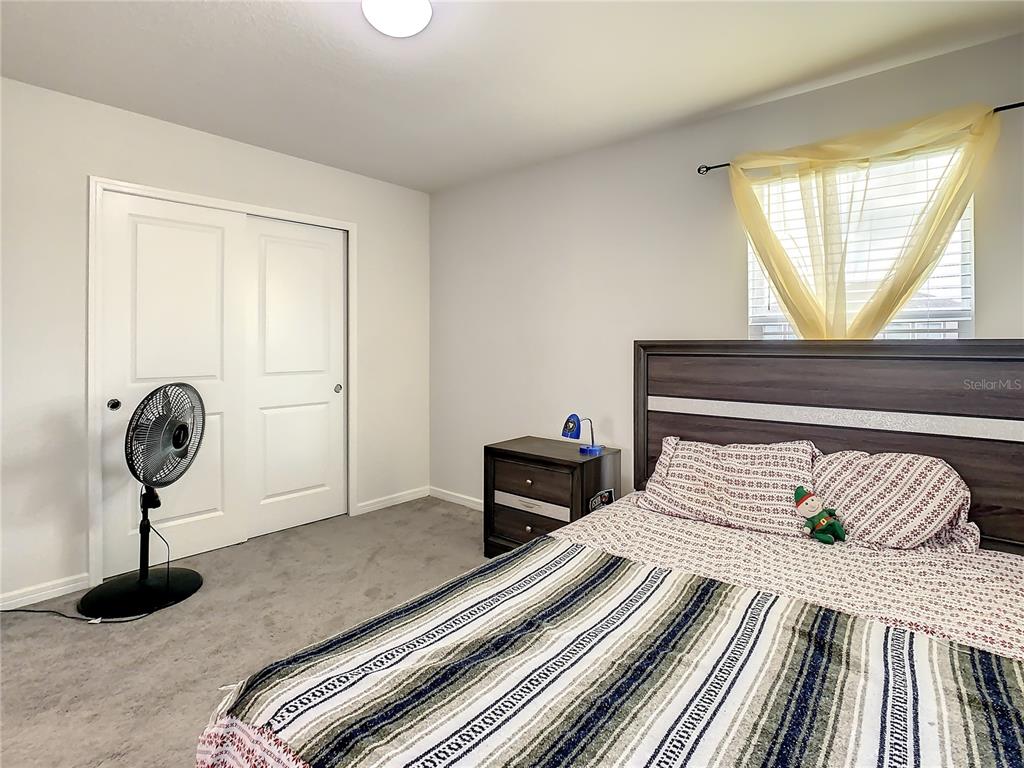 30344 Marquette Avenue Wesley Chapel, FL 33545 - Photo 35 of 71 a bedroom with a bed and a window