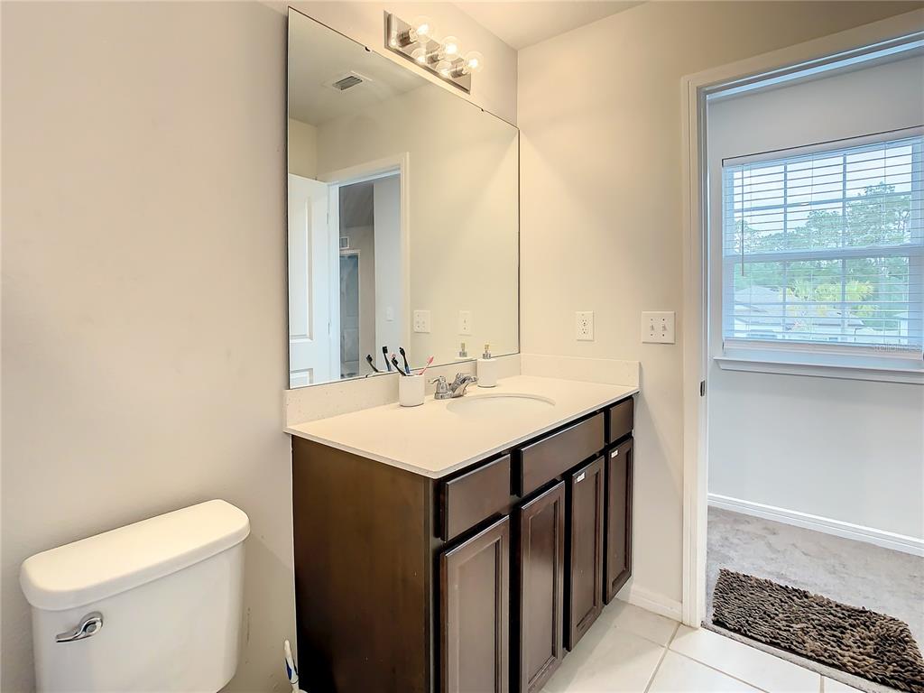 30344 Marquette Avenue Wesley Chapel, FL 33545 - Photo 37 of 71 a bathroom with a sink a toilet and a mirror