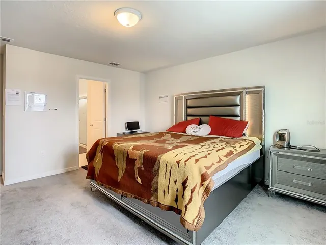 a view of a house with a yard and potted plants