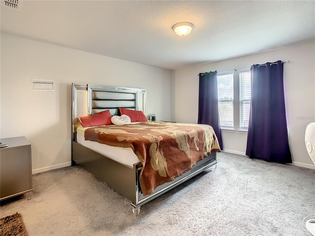 30344 Marquette Avenue Wesley Chapel, FL 33545 - Photo 40 of 71 a bedroom with a bed and window