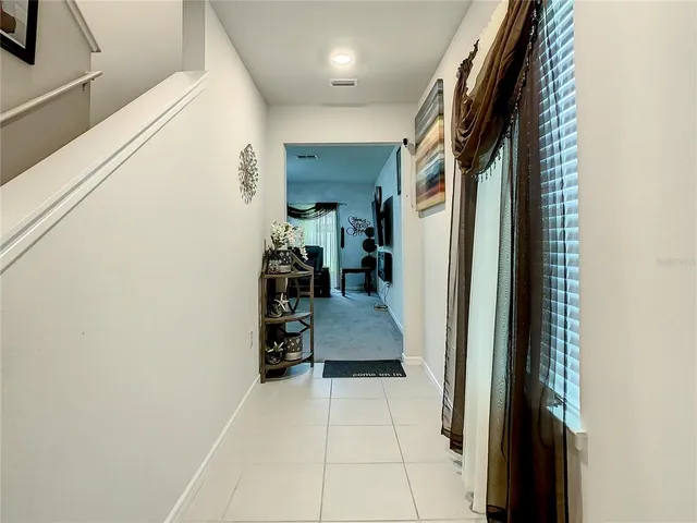 a kitchen with stainless steel appliances kitchen island granite countertop a sink and a refrigerator