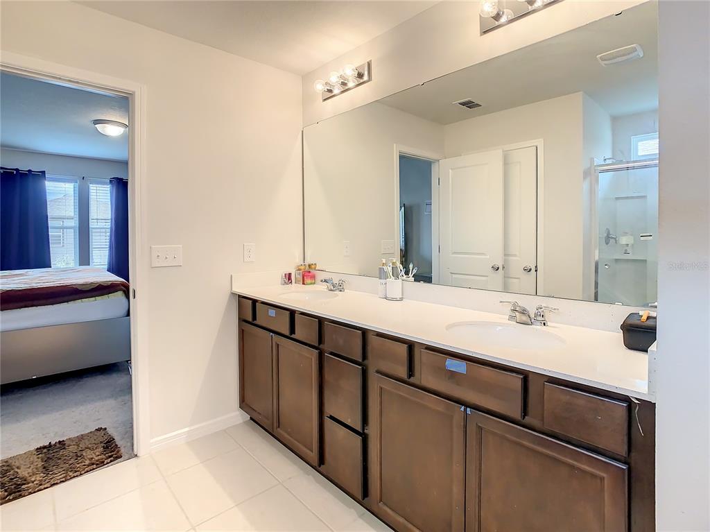 30344 Marquette Avenue Wesley Chapel, FL 33545 - Photo 44 of 71 a bathroom with a double vanity sink and a mirror
