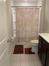 30344 Marquette Avenue Wesley Chapel, FL 33545 - Photo 46 of 71 a bathroom with a toilet and a shower curtain