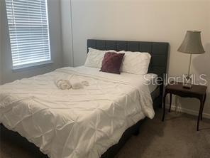 30344 Marquette Avenue Wesley Chapel, FL 33545 - Photo 49 of 71 a large bed sitting in a bedroom next to a lamp