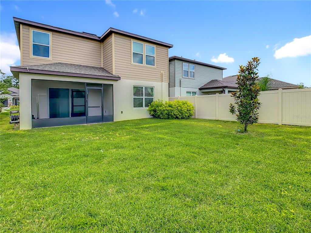 30344 Marquette Avenue Wesley Chapel, FL 33545 - Photo 55 of 71 a view of a house with a yard and potted plants