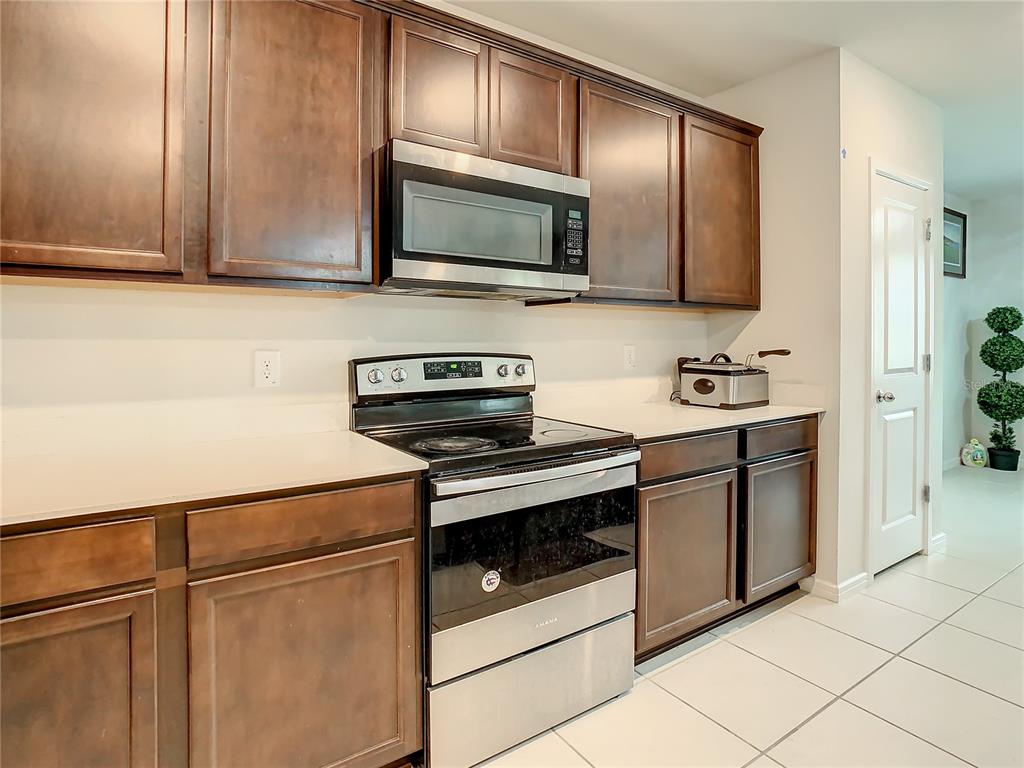 30344 Marquette Avenue Wesley Chapel, FL 33545 - Photo 7 of 71 a kitchen with stainless steel appliances a stove microwave and sink