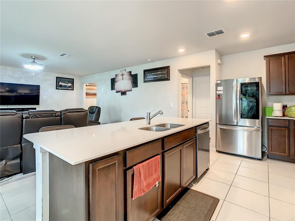 30344 Marquette Avenue Wesley Chapel, FL 33545 - Photo 10 of 71 a kitchen with stainless steel appliances a sink a stove a refrigerator and cabinets