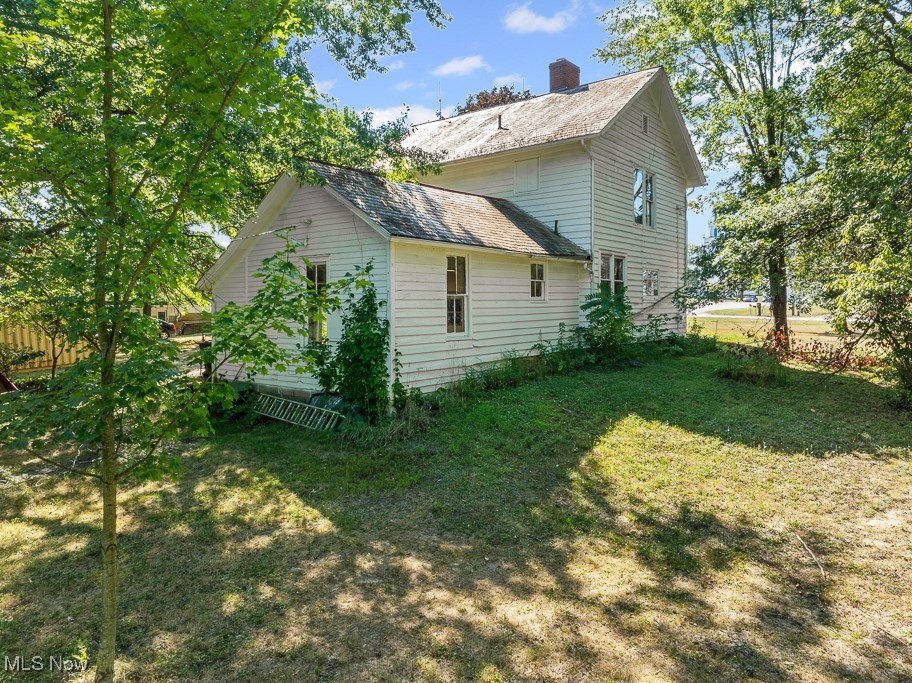 6727 Waterloo Road Atwater, OH 44201 - Photo 6 of 48 View of side of property featuring a yard and a chimney