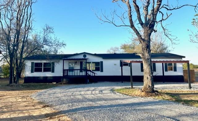 a house that has a tree in front of it
