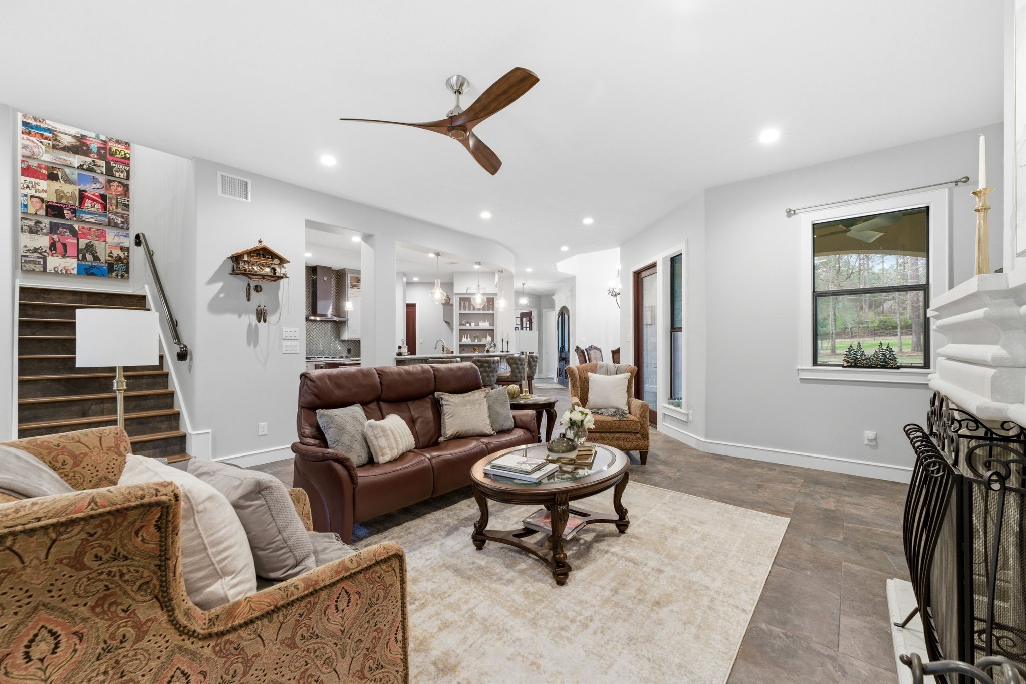 280 Sundog Road Huntsville, TX 77340 - Photo 13 of 50 Family room perspective highlighting the open flow toward the kitchen and main living areas, creating an inviting space for gathering and entertaining.