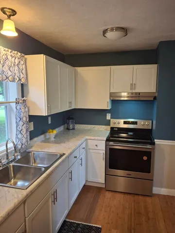a kitchen with a sink stove and cabinets