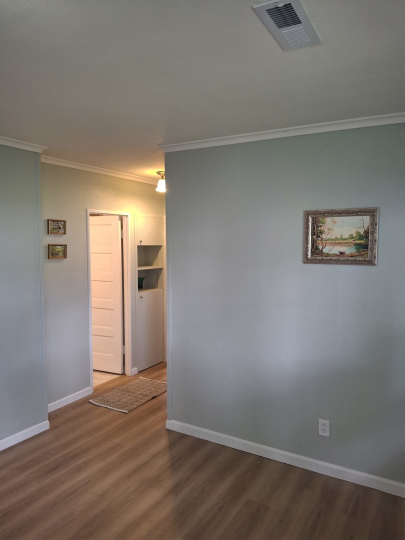304 Depot Street Walnut, IL 61376 - Photo 7 of 12 a view of an empty room with wooden floor and a window
