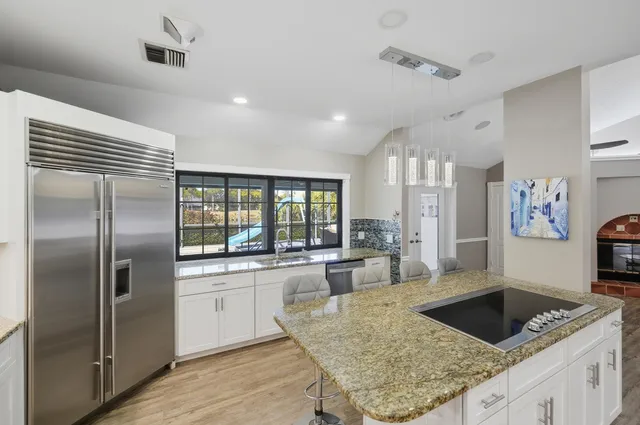 a backyard of a house with table and chairs