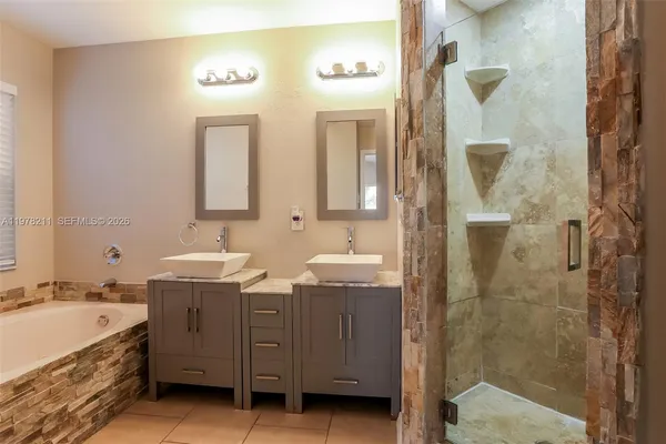 a bathroom with a granite countertop sink mirror and shower